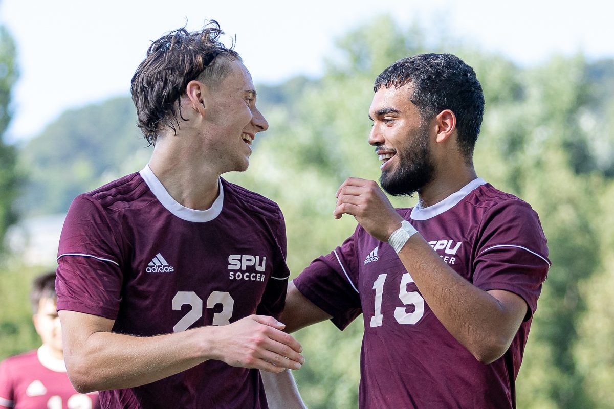 Seattle Pacific University midfielder Brady Fendrich (23) celebrates with forward Luis Zazueta (15) after scoring to against Antiguoko KE during the first half of a pre season soccer match on Thursday, Aug. 10, 2023, in San Sebastian, Spain. Seattle Pacific University won 2-0.