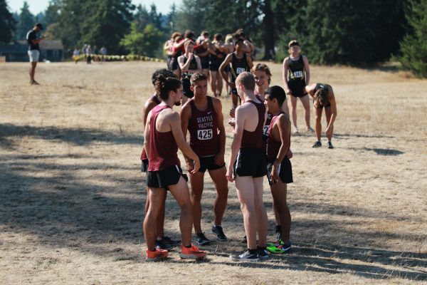 Seattle Pacific University senior Brennan LeBlanc talks with his teammates ahead of the PLU Invitational 8k race in Tacoma, Wash., on Saturday, Sept. 16, 2023. The Falcons finished 5th overall and second out of the Division 2 competition.