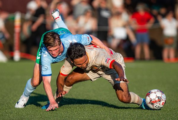 Ballard FC midfielder Danny Robles (26) battles for the ball with Lane United forward Tadhg Walsh (11) during the first half of a USL2 soccer game in Seattle, Wash., on Friday, May 26, 2023. Ballard FC won 3-0.
