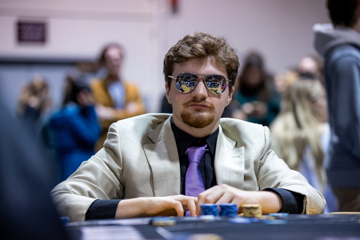 Callaghan Buechel sits at a poker table at the spring First Friday Casino Night on Friday, March 31, 2023.