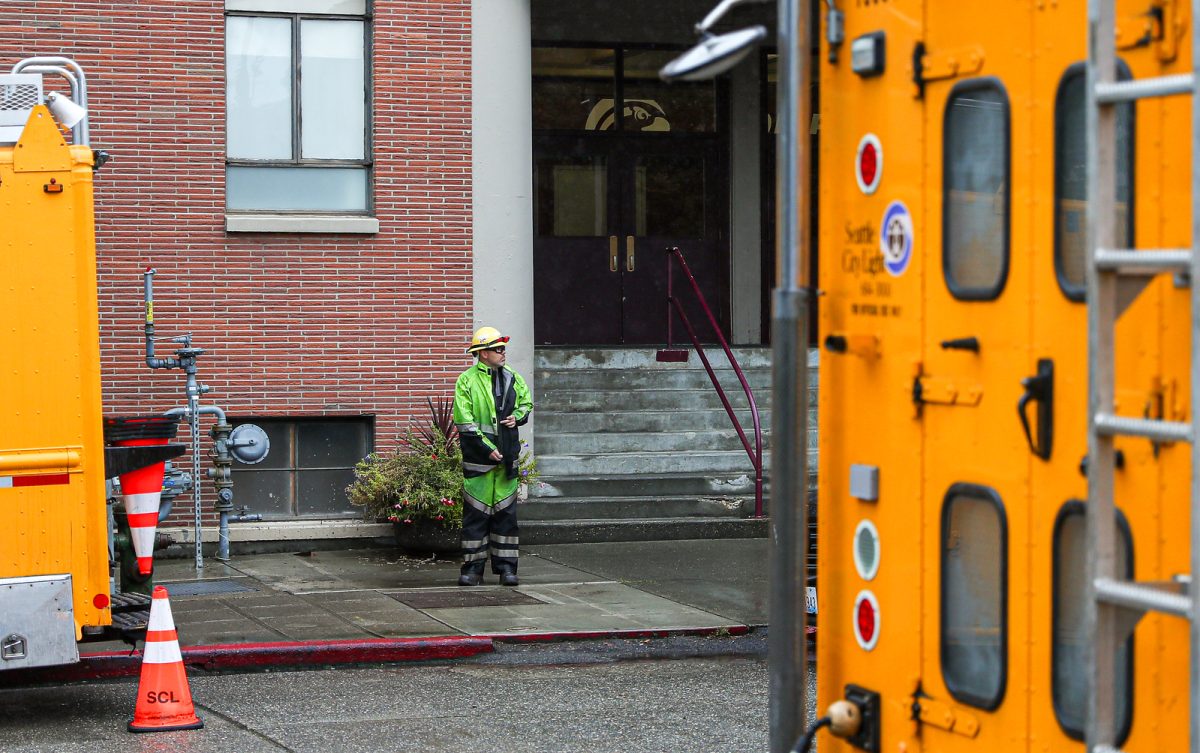 A Seattle City Light worker heads back to his truck after working to get power back to Otto Miller and Royal Brougham Pavilion on Monday morning, Sept. 25, 2023. Due to the power outage classes in the two buildings were moved for the day.
