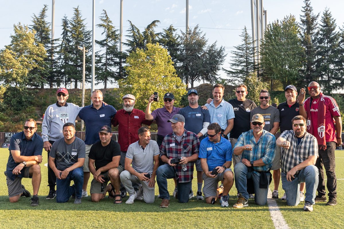 The 1993 Seattle Pacific Mens soccer team posses for a photo after receiving their championship rings at halftime during Legacy night on Saturday, Sept. 16, 2023, in Seattle.