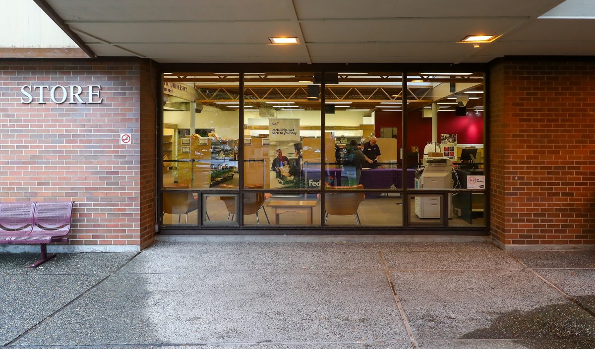 A student is helped by a FedEx worker in the new Seattle Pacific University Mailroom on Monday, Sept. 25, 2023. The mailroom was moved into, and combined with, the bookstore for the 2023 school year.