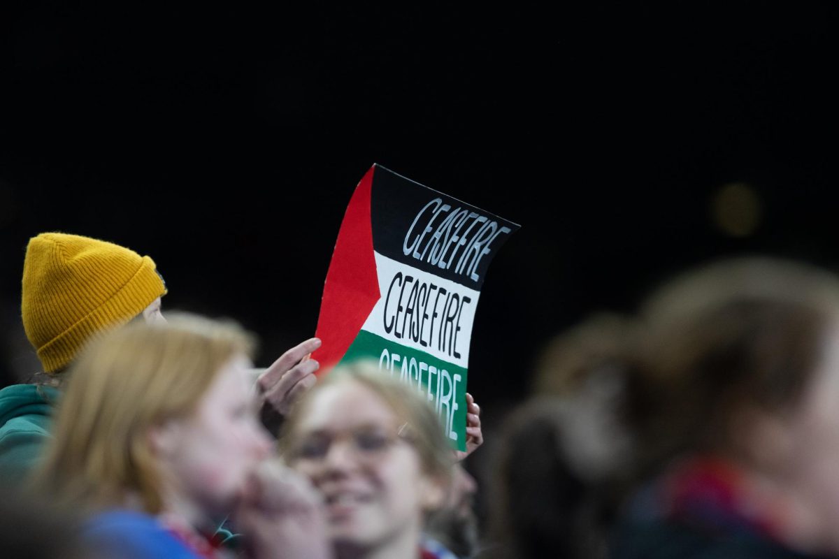 A fan holds up a sign depicting a Palestinian flag with the word ceasefire repeated on it during the NWSL quarterfinal match between the OL Reign and Angel City SC on Friday, Oct. 20, 2023 in Seattle.