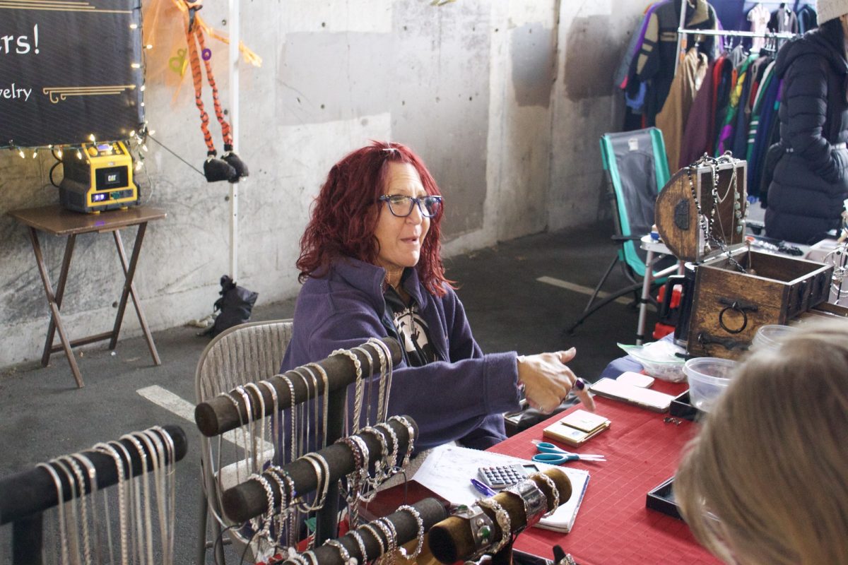 Morse interacts with customers at her Fremont Sunday Market booth, Finders Keepers.