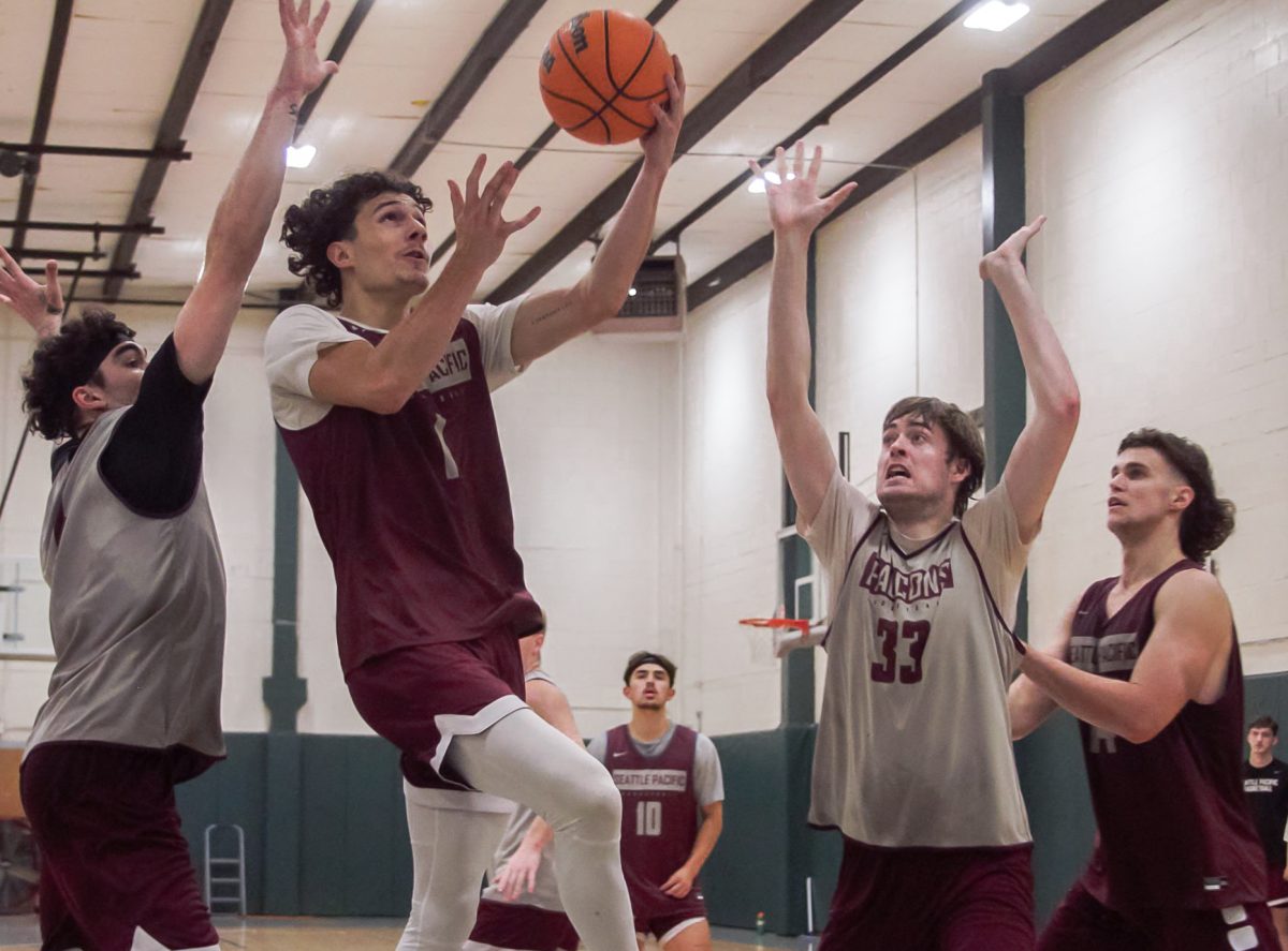 Sophomore guard Owen Moriarty (1) goes for a layup while defended by Nikias Schoenerstedt (33) and Jonas La Tour (left) during practice on Tuesday, Oct. 31, 2023, in Seattle.