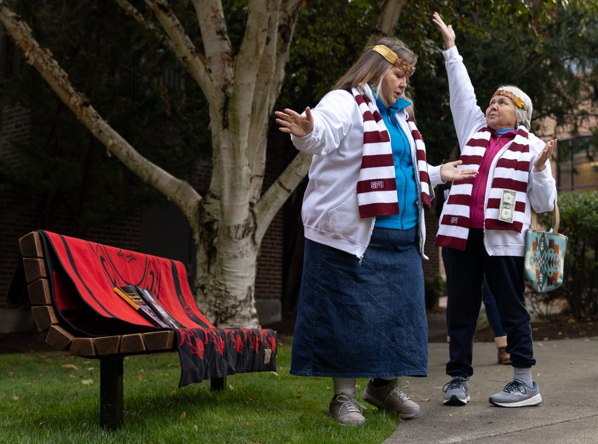 Members of the Snoqualmie Tribe perform a prayer of blessing at the friendship bench dedication ceremony behind Alexander and Adelaide Hall on Tuesday, Oct. 31, 2023, in Seattle. The bench will serve as a reminder to honor and maintain the 50-year legacy of friendship that Professor Tollefson fostered with the Coast Salish and Alaskan tribes and to continue to cultivate true friendships with indigenous neighbors on this land.