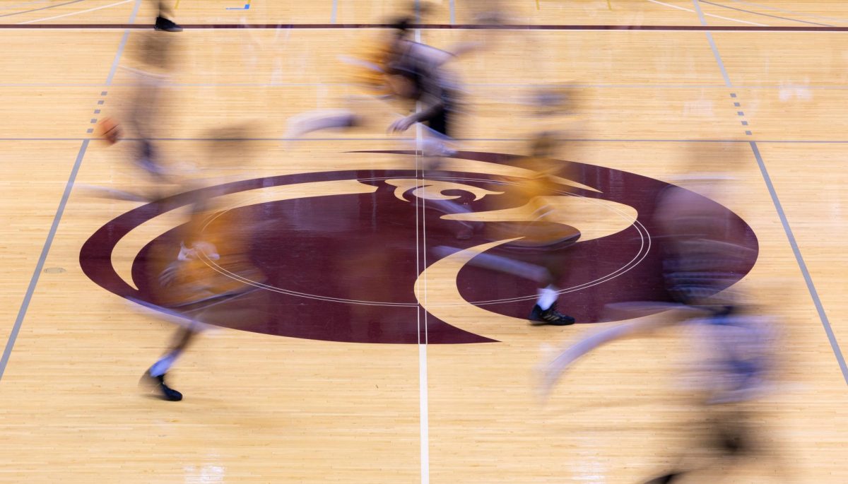 FILE - Players make their way over the Seattle Pacific University Athletics logo during a basketball game on Nov. 18, 2023 in Seattle.