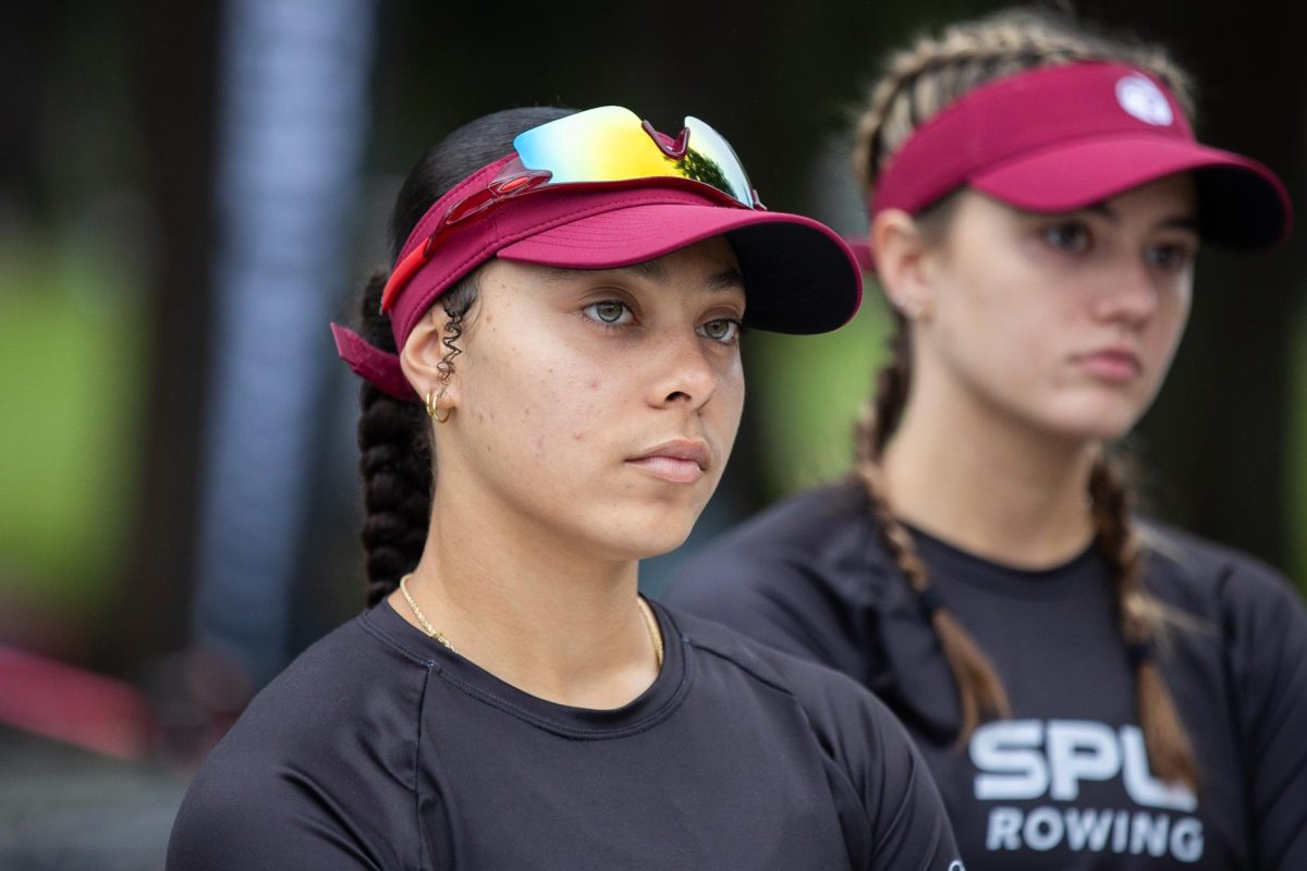 Sophomore rower Raquel Wesley listens to coach Caitlin McClain give final instruction to the team before racing at the American Lake Fall Classic on Sunday, Oct. 8, 2023, in Lakewood, Washington. 