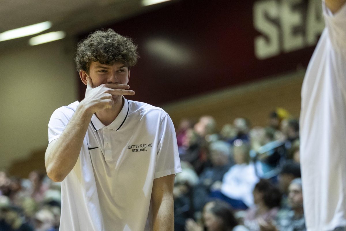 Seattle Pacific University Freshman Mens Basketball player David Zachman reacts to a three point shot made by a teammate during the second half of an NCAA basketball game against Western Washington on Saturday, Jan. 13, 2023, in Seattle.