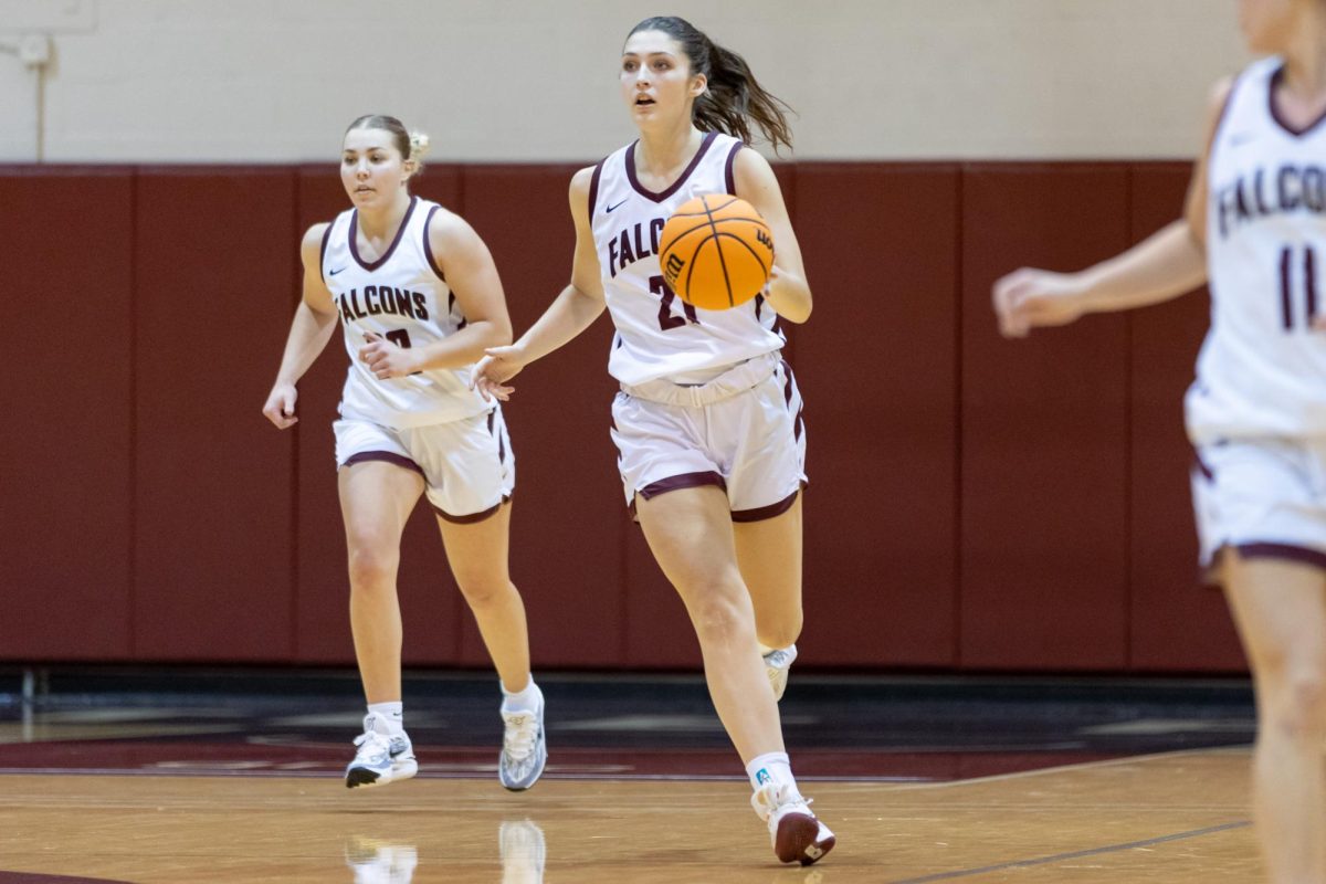 Junior forward Olivia Mayer (21) moves the ball up court against George Fox on Saturday, Dec. 9, 2023, at Royal Brougham Pavilion in Seattle.