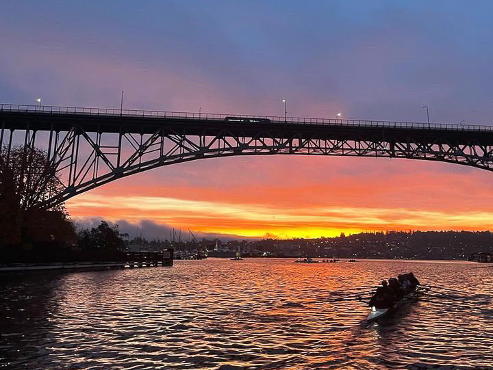A Seattle Pacific University Rowing boat makes its way under the Aurora Bridge during an early morning practice. Courtesy of Cookie Yitbarek
