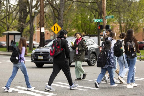 Students cross the street as cars wait to turn left on to Nickerson street from 3rd Ave. west on Tuesday, April 9, 2024, in Seattle.