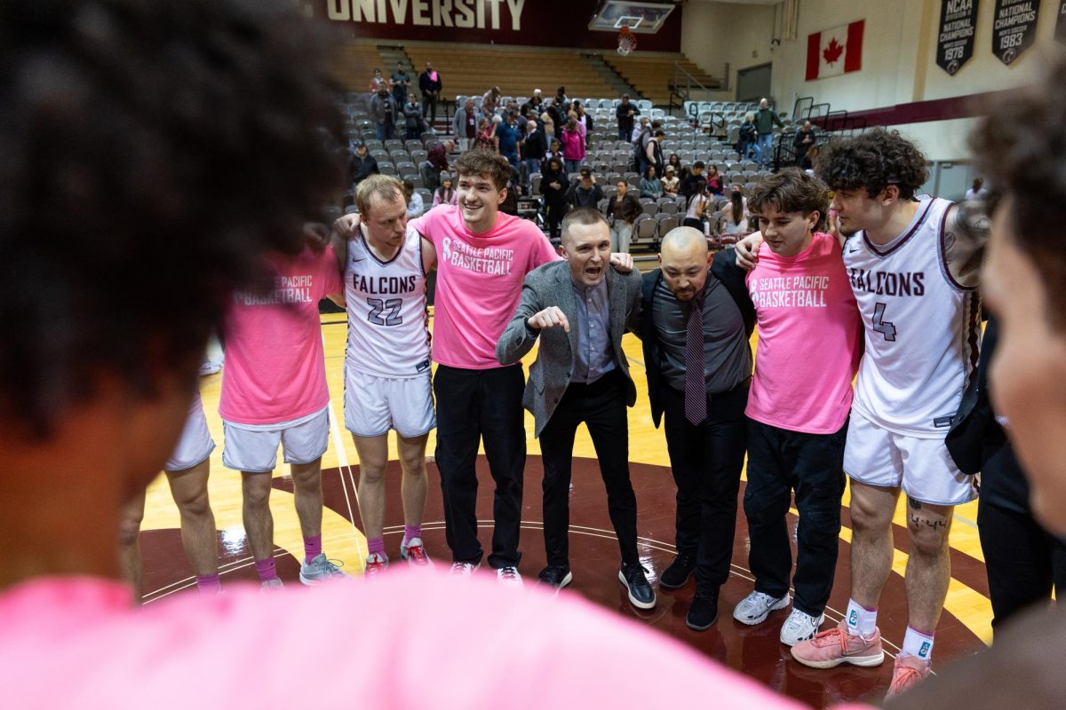 Seattle Pacific University head coach Keffrey Fazio (center) gives a speech to his team after defeating Central Washington University on Feb. 1, 2024, in Seattle. After one season as the interim head coach following the departure of Grant Leep last year, it was decided that the interim tag would be removed and Fazio would be officially placed in charge of the program.