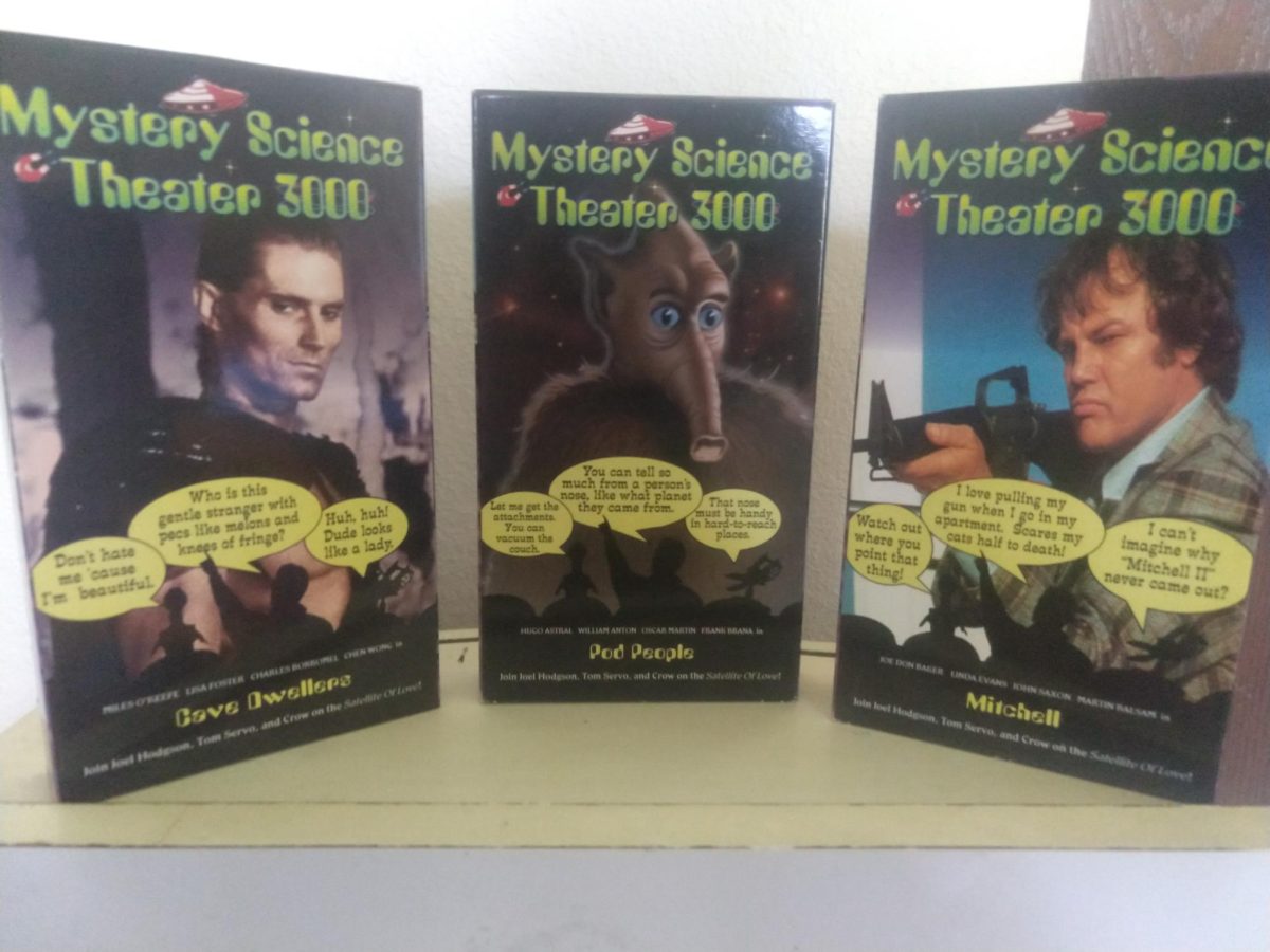 Three copies of Mystery Science Theater 3000 are displayed for a photo.
