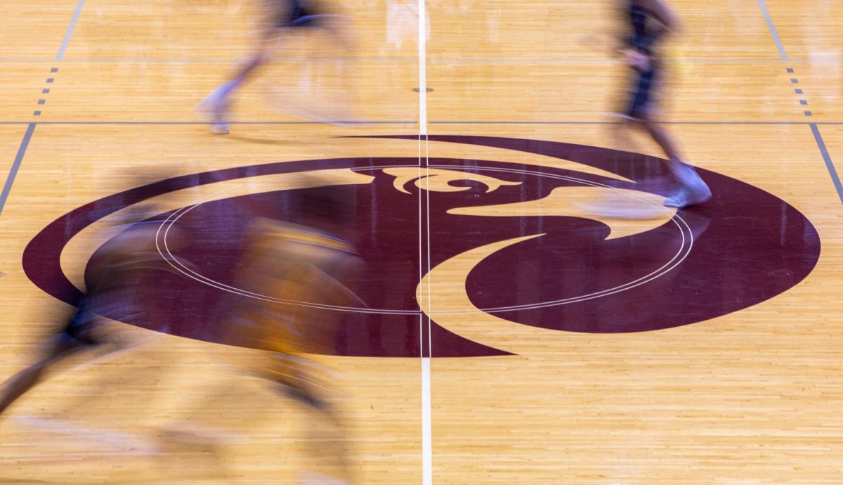FILE - Players make their way over the Seattle Pacific University Athletics logo during a basketball game on Nov. 18, 2023 in Seattle. During the 2023-2024 college basketball season the Dartmouth mens basketball team unionized paving the way for others to do the same if they wanted to.