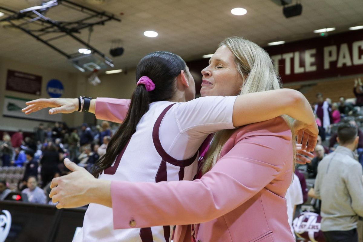 Womens basketball assistant coach Karen Byers embraces Seattle Pacific University guard Lolo Weatherspoon (10) after a game against Central Washington University on Feb. 1, 2024, in Seattle.