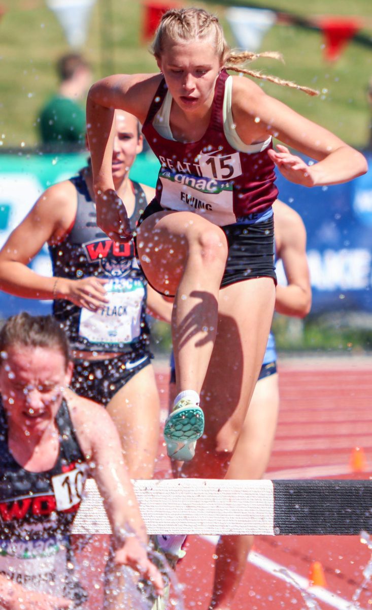Maya Ewing (15) clears the water jump during the steeplechase at the GNAC Track and Field Championships on Friday, May 10, 2024, in Ellensburg, Wash.