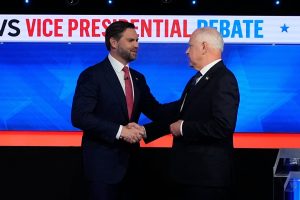 Vice presidential candidates J. P Vance and Tim Waltz shaking hands before their debate Tuesday, Oct. 1.