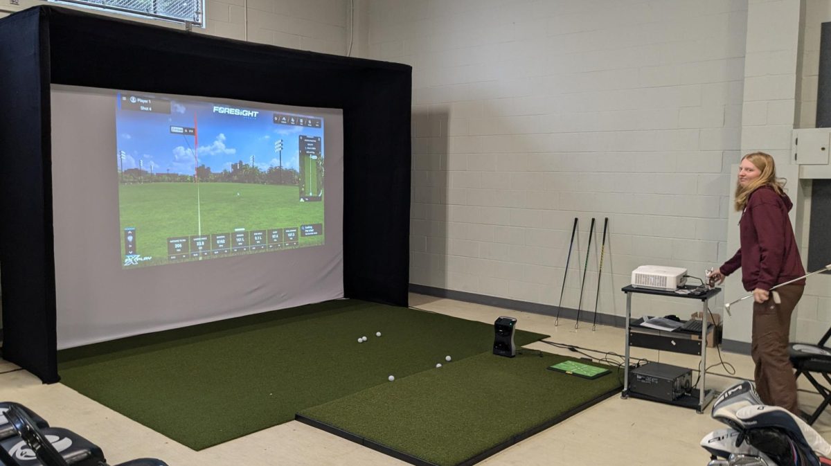 Student athlete Zoe Garcia utilizes the SPU Women's Golf facility's virtual golfing range.