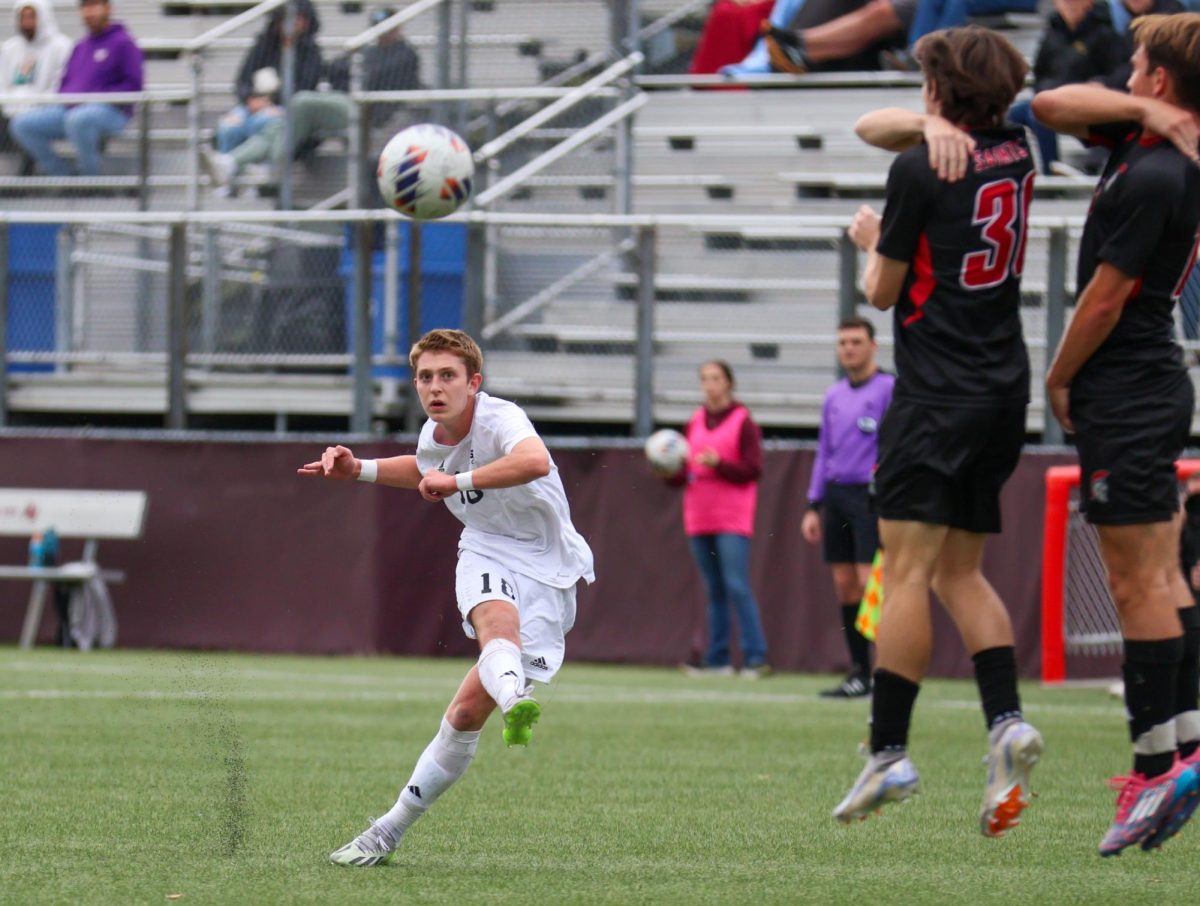 SPU sophomore Owen Swartout (18) takes the penalty kick to assist in the goal against Saint Martin's University