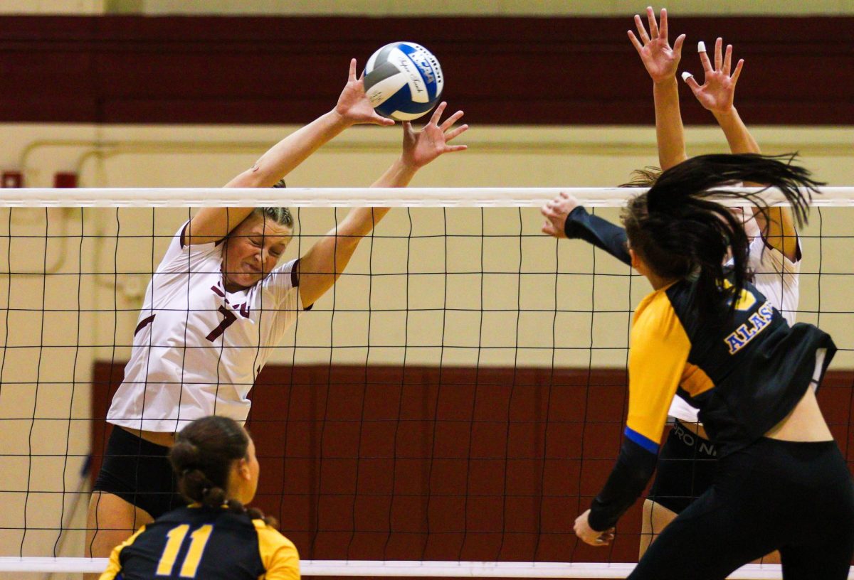 Senior Hannah Hair (7) saves the set by blocking the spike from Alaska Anchorage.

