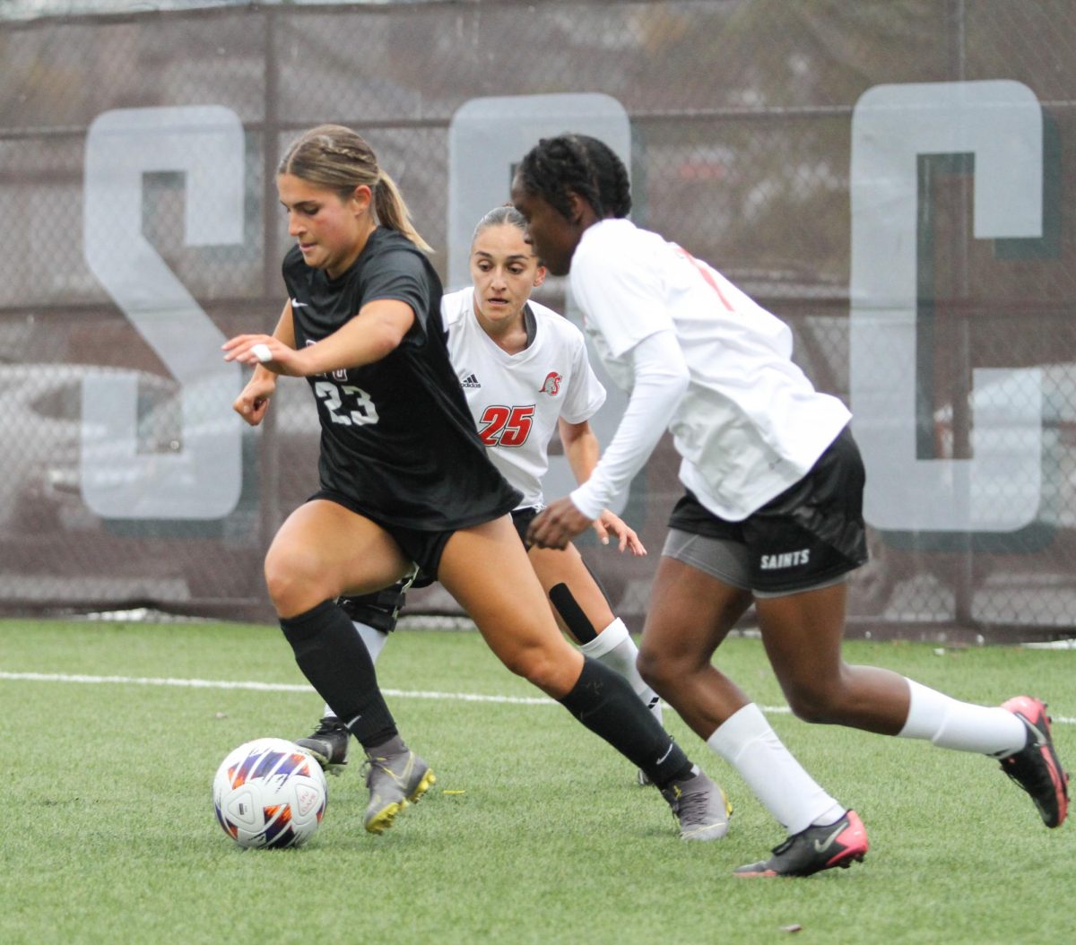 Taylor Krueger (23) keeping control of the soccer ball against St. Martins soccer players in the 1st half of the women's soccer game.