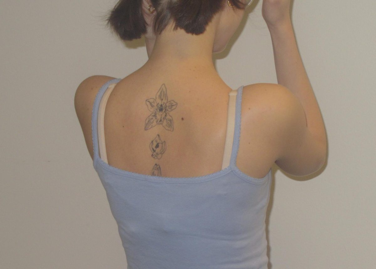 First year student Gracie Clauson displaying her back tattoo she got at 18.