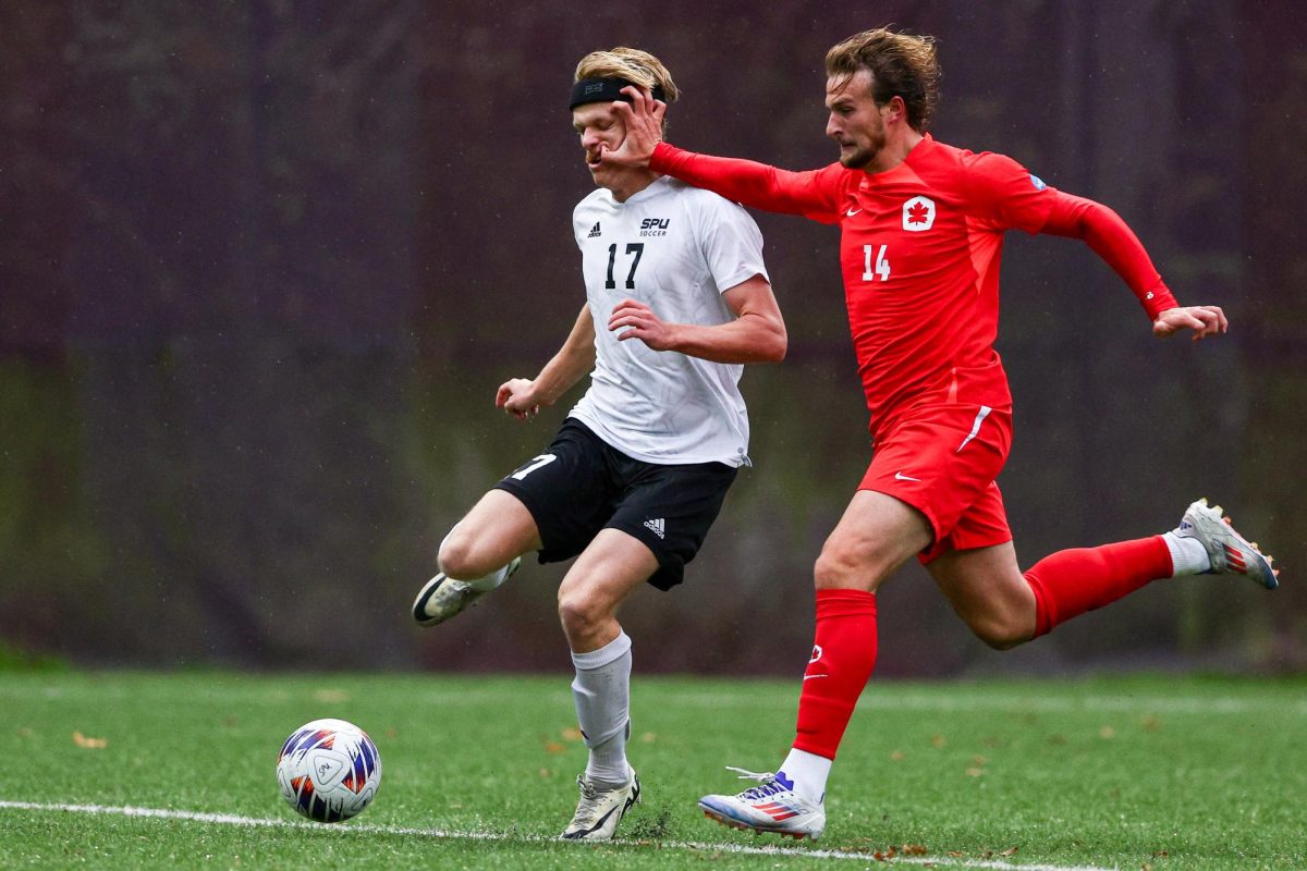 Seattle Pacific forward Judah Johnston (17) fights for the ball with Simon Fraser defender Brandon Torresan (14) during the second half of a GNAC conference match, Oct. 31, 2024, in Seattle.