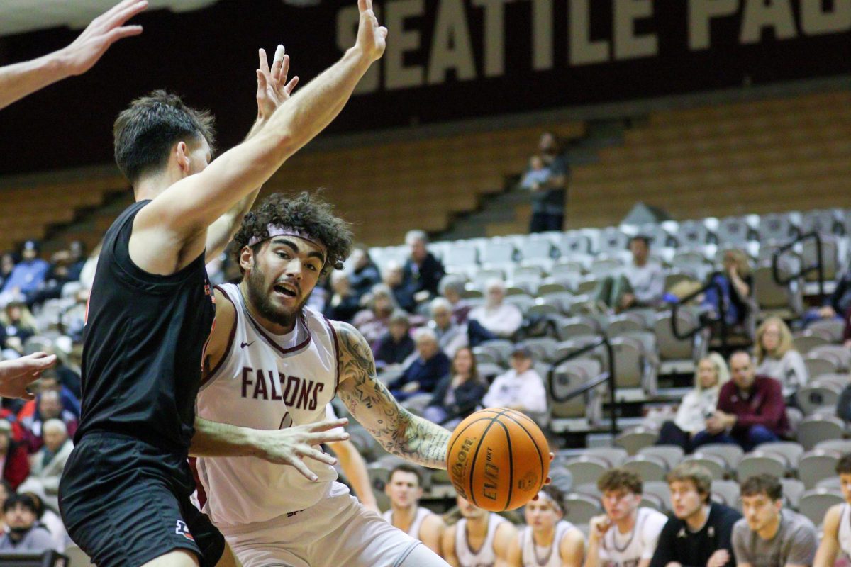 SPU Junior Jonas La Tour (4) fights to make a lay up against Lewis & Clark University Saturday, Nov 2, 2024 in Seattle.