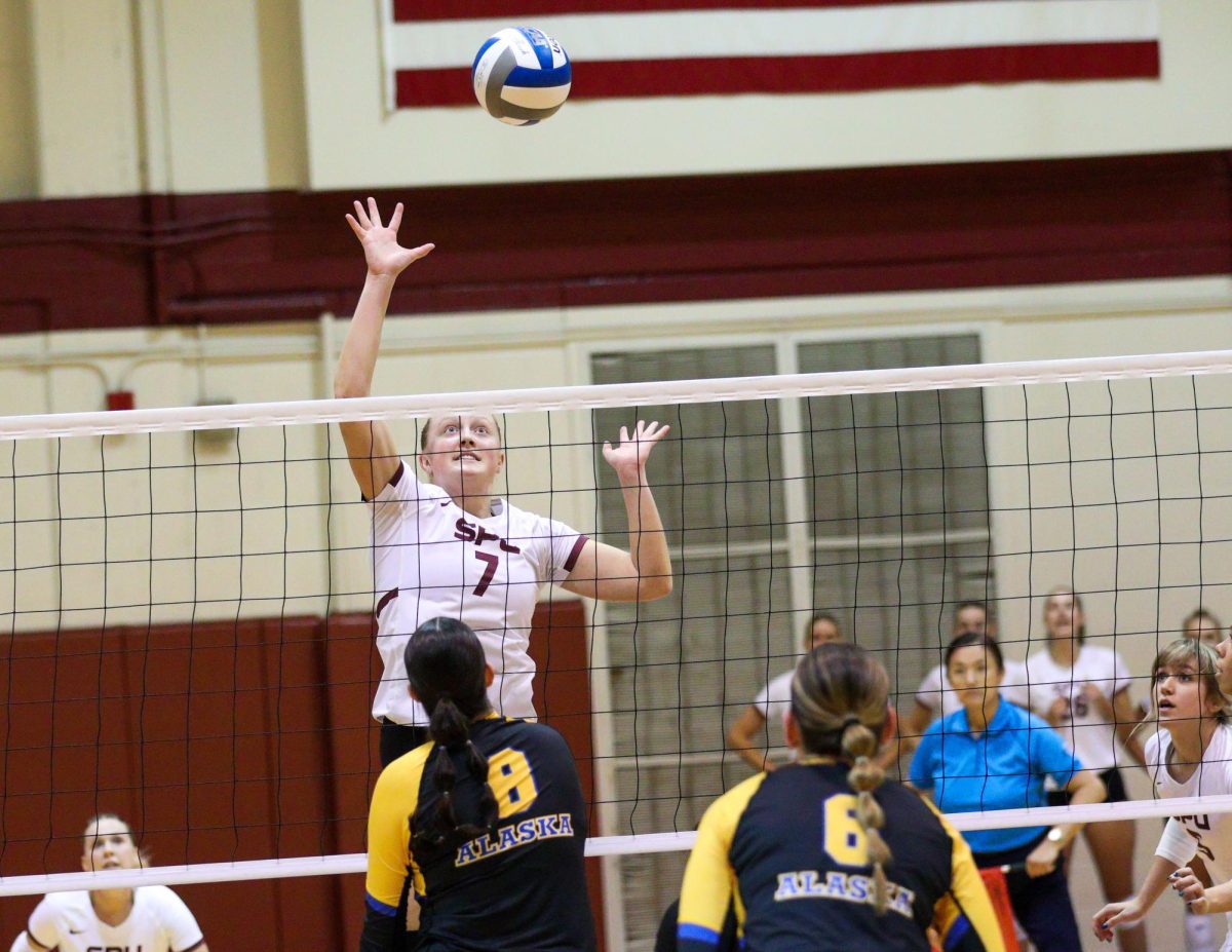 Senior Hannah Hair (7) leaps to to drive the kill against University of Alaska, Anchorage.