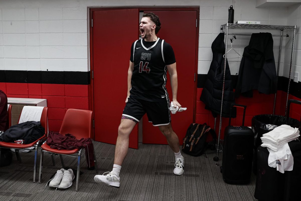 Seattle Pacific men's basketball junior forward Trace Evans (14) celebrates in the locker room after the Falcons defeated Northwest Nazarene in the GNAC tournament semifinals, Friday, Mar 7, 2025, in Lacey, Wash.