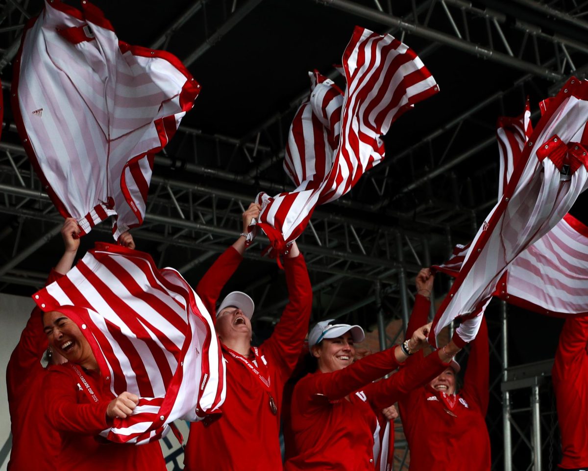 The Indiana rowing team smiles after ripping off their tear-away pants during the awards ceremony for the Windermere Cup, Saturday, May 3, 2025, in Seattle.