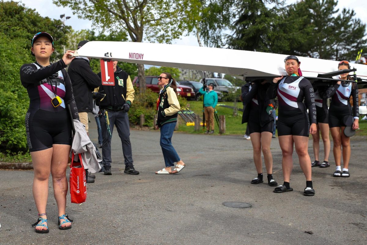 Coxswain Lexi Roybal waits for direction from the dock master before launching from Conibear Shellhouse, Saturday, May 3, 2025, in Seattle.