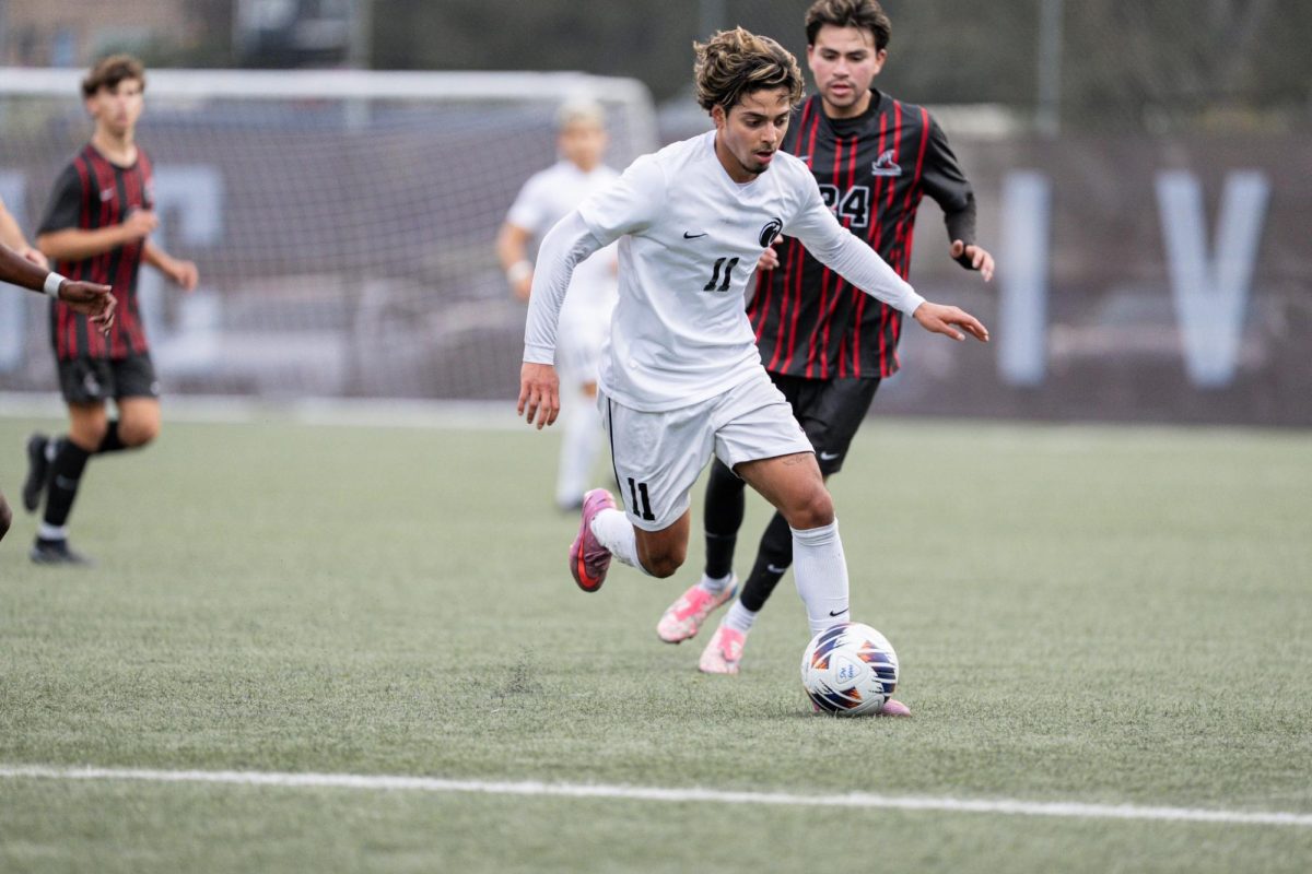 Senior Orlando Erazo dribbling the ball up-field at Interbay Stadium against Northwest Nazarene.