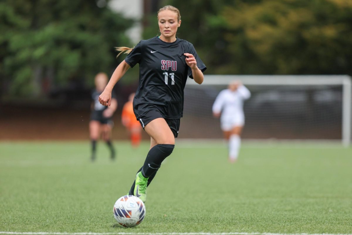 Senior Kayla Wallace dribbling down the field against MSU Billings.