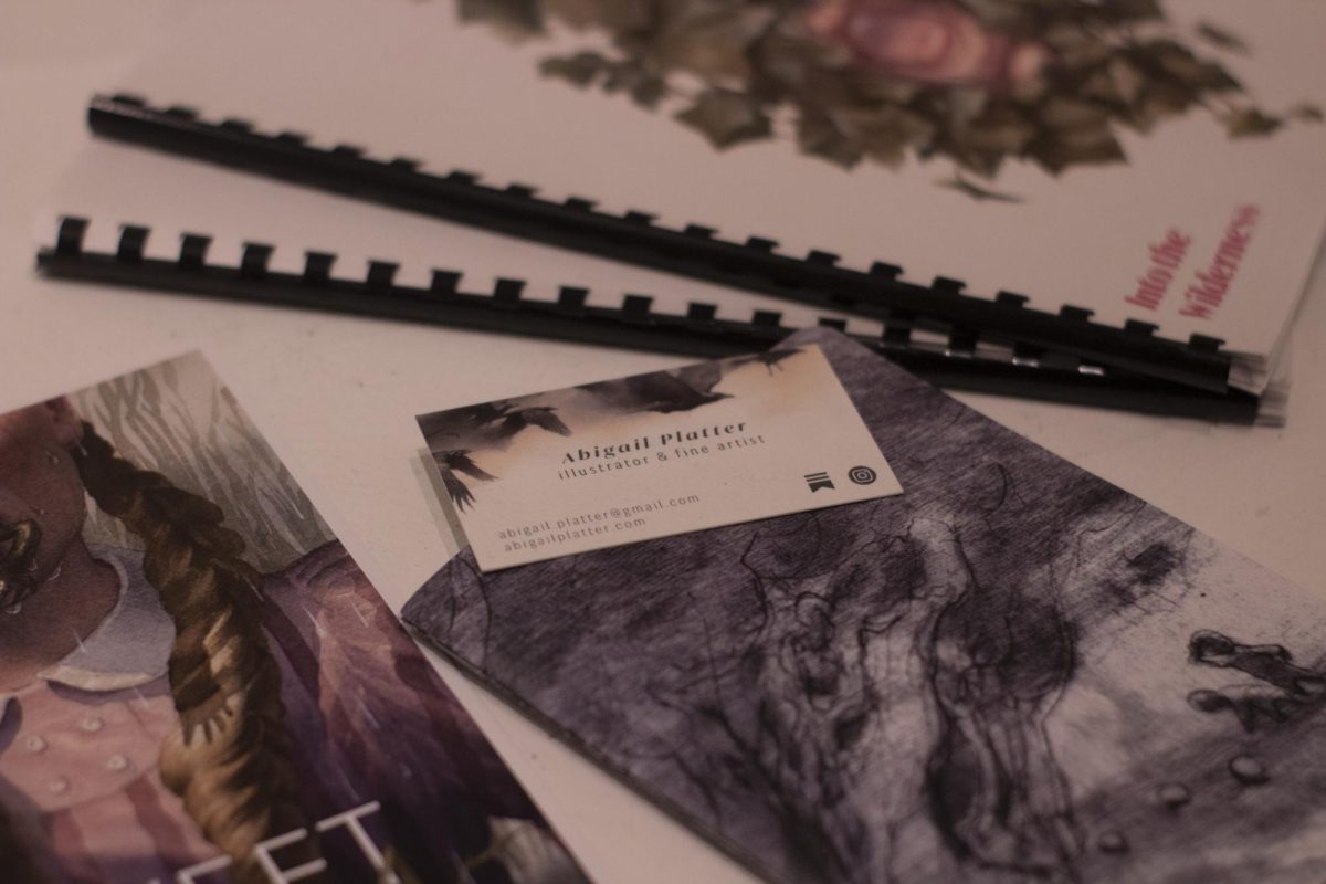 Abigail Platter's business card among her other works in SPAC Gallery.