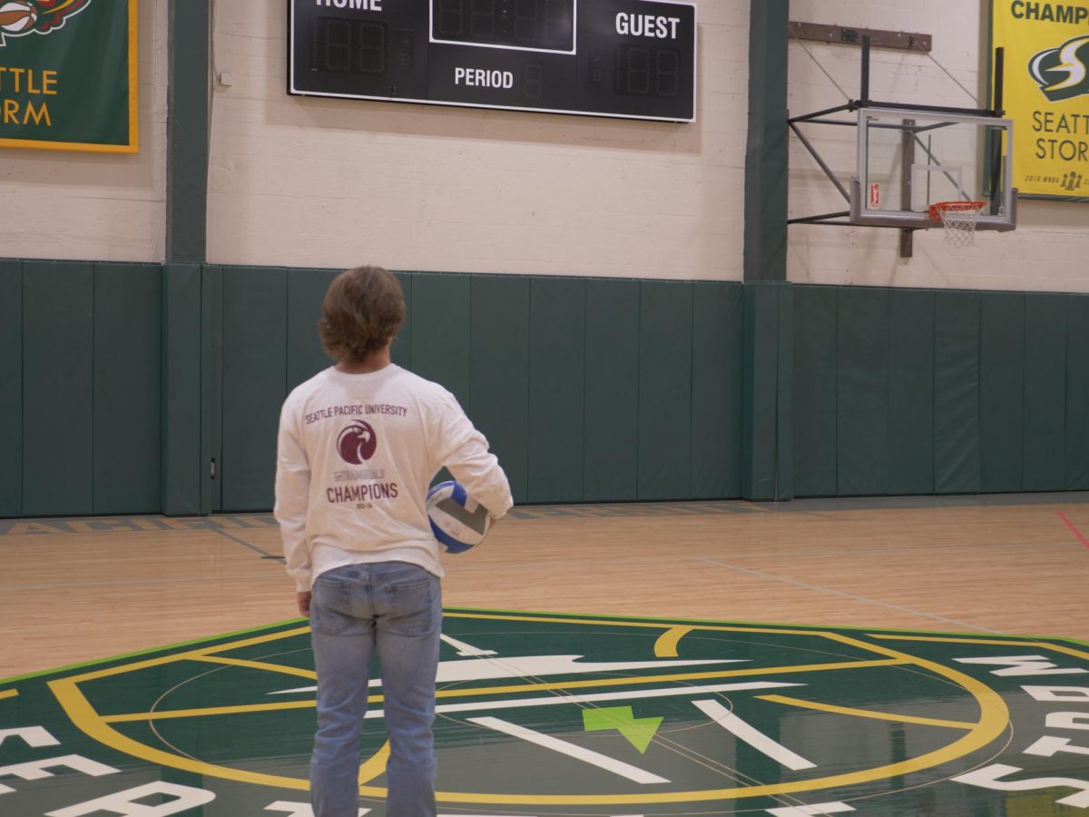 Senior Justice Dean stands in Royal Brougham Pavilion's lower basketball court