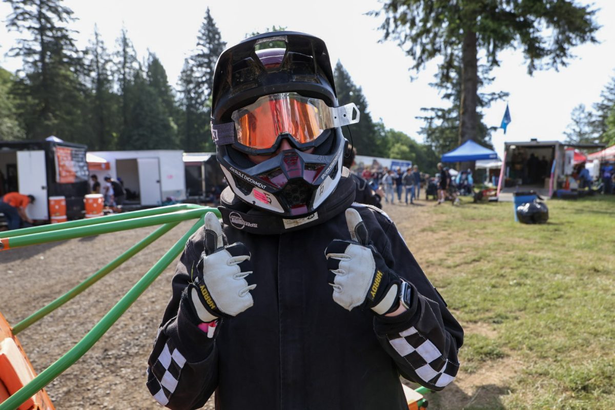 Racer holds two thumbs up at Baja SAE in Washougal, WA.